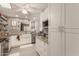 Well-lit kitchen featuring white cabinetry, stainless appliances, and modern finishes at 11468 N Desert Hills Dr, Sun City, AZ 85351