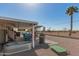 Covered outdoor space with multiple dining sets and barbecue grill, ideal for outdoor meals and entertaining guests at 11468 N Desert Hills Dr, Sun City, AZ 85351