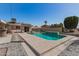 Aerial view of backyard pool featuring stylish lounge chairs and a covered outdoor seating area, ideal for relaxation at 11468 N Desert Hills Dr, Sun City, AZ 85351