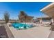 Backyard pool featuring lounge chairs and a covered outdoor seating area with bar, perfect for summer days and entertaining at 11468 N Desert Hills Dr, Sun City, AZ 85351