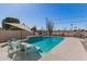 Beautiful backyard pool with a lovely water feature and table with umbrella, perfect for relaxation and entertainment at 11468 N Desert Hills Dr, Sun City, AZ 85351