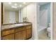 Well-lit bathroom featuring a large mirror, spacious vanity, and a shower-tub combo at 1216 E Rancho Dr, Phoenix, AZ 85014