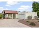 This home features a red tile roof, a clean white exterior, and an easy-to-maintain desert landscape at 1216 E Rancho Dr, Phoenix, AZ 85014