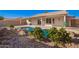 Private backyard featuring a sparkling pool, covered patio, and serene landscaping at 1227 W 12Th Ave, Apache Junction, AZ 85120