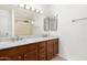 Bathroom features a double sink, white marble countertop, and a large mirror at 1227 W 12Th Ave, Apache Junction, AZ 85120