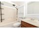 Cozy bathroom with tiled shower, decorative storage cabinet, and updated vanity at 1227 W 12Th Ave, Apache Junction, AZ 85120