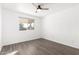 Bright bedroom featuring modern ceiling fan, hardwood floors, and natural light from a large window at 1227 W 12Th Ave, Apache Junction, AZ 85120