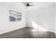 Bedroom features a ceiling fan and a window, with wood-look floors at 1227 W 12Th Ave, Apache Junction, AZ 85120