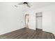 Neutral bedroom with wood-look floors, closet and a ceiling fan at 1227 W 12Th Ave, Apache Junction, AZ 85120