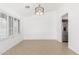 Open dining room area with tile floors, plantation shutters, and modern lighting at 1227 W 12Th Ave, Apache Junction, AZ 85120