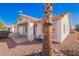 Exterior elevation of house featuring desert landscaping with gravel and plants at 1227 W 12Th Ave, Apache Junction, AZ 85120