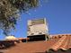 View of the roof-mounted air conditioning system with rust-colored tiles under a bright blue sky at 1384 N Santa Anna Ct, Chandler, AZ 85224