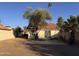 View of the house and patio from the yard showing sliding glass door access to home at 1384 N Santa Anna Ct, Chandler, AZ 85224