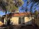 Backyard showcasing desert landscape with an inviting patio and sliding glass door to the home at 1384 N Santa Anna Ct, Chandler, AZ 85224