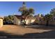 Backyard features low maintenance landscaping with view of single story home, tile roof, and desert trees at 1384 N Santa Anna Ct, Chandler, AZ 85224