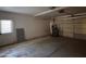 Spacious garage with ample room for parking and storage and a door to the house at 1384 N Santa Anna Ct, Chandler, AZ 85224