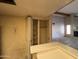 Kitchen pantry with shelving and a view into the living room with a fireplace at 1384 N Santa Anna Ct, Chandler, AZ 85224