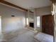 Inviting living area showcasing a fireplace, beamed ceiling and bright windows, perfect for customization at 1384 N Santa Anna Ct, Chandler, AZ 85224