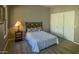 Bedroom with a white bed, sliding door closet, and ample lighting at 14850 E Grandview Dr # 233, Fountain Hills, AZ 85268