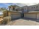 Exterior elevation of a multi-story home, boasting a three-car garage and desert landscape at 14850 E Grandview Dr # 233, Fountain Hills, AZ 85268