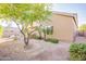 Backyard featuring flowering trees and low maintenance landscaping surrounding the home's exterior at 15237 S 47Th Way, Phoenix, AZ 85044