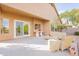 Back patio with stylish wicker furniture, attached table, and convenient sliding door access to the home at 15237 S 47Th Way, Phoenix, AZ 85044