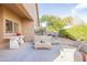 Covered back patio with outdoor seating, a built-in table, and mature landscaping in a well-maintained yard at 15237 S 47Th Way, Phoenix, AZ 85044