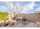 The backyard patio features a green metal dining set with block wall and drought-tolerant landscaping at 15237 S 47Th Way, Phoenix, AZ 85044