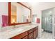 Bright bathroom with granite topped vanity with dual sinks and gray tiled shower stall at 15237 S 47Th Way, Phoenix, AZ 85044