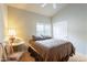 Bedroom with a ceiling fan, window, wood floors, and a double door closet at 15237 S 47Th Way, Phoenix, AZ 85044