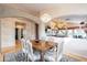 Elegant dining room with decorative lighting, an ornate table set for six, and access to other living spaces at 15237 S 47Th Way, Phoenix, AZ 85044