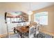 Elegant dining room with decorative lighting, an ornate table set for six, and access to other living spaces at 15237 S 47Th Way, Phoenix, AZ 85044