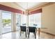 Bright dining room featuring a glass table, modern chairs, and patio access at 15237 S 47Th Way, Phoenix, AZ 85044