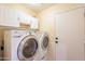 Laundry room showing a washer, dryer and storage cabinets at 15237 S 47Th Way, Phoenix, AZ 85044