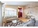 Comfortable living space featuring bright walls, hardwood floors, an archway, and a glass-topped coffee table at 15237 S 47Th Way, Phoenix, AZ 85044