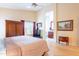 Bedroom with hardwood floors, a ceiling fan and an ensuite bathroom in view at 15237 S 47Th Way, Phoenix, AZ 85044