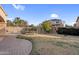 View of the backyard, pool, metal fence, hardscape and grass at 15635 W Montecito Ave, Goodyear, AZ 85395