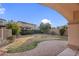 A covered patio with view of a manicured backyard with grass and hardscape at 15635 W Montecito Ave, Goodyear, AZ 85395