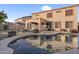 Backyard pool with a covered patio of a two-story house, complimented by mature landscaping for private outdoor living at 15635 W Montecito Ave, Goodyear, AZ 85395