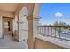 Balcony with decorative arches and a view of the surrounding neighborhood and blue sky at 15635 W Montecito Ave, Goodyear, AZ 85395