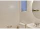 Bright half bathroom with a pedestal sink and window at 15635 W Montecito Ave, Goodyear, AZ 85395