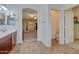 Open bathroom layout with double sink vanity, tile floors, and an open door at 15635 W Montecito Ave, Goodyear, AZ 85395