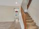 Inviting entryway featuring neutral tones, tile accents, and a carpeted staircase for a welcoming atmosphere at 15635 W Montecito Ave, Goodyear, AZ 85395