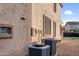 A low angle view of the home's exterior showing stucco wall, and two HVAC systems at 15635 W Montecito Ave, Goodyear, AZ 85395