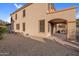 Exterior view of the stucco home with an arched covered patio and an adjacent gravel area at 15635 W Montecito Ave, Goodyear, AZ 85395