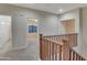 Hallway with wood banister and carpet, leads to bedrooms at 15635 W Montecito Ave, Goodyear, AZ 85395