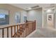 Upstairs hallway with natural light and wood banister at 15635 W Montecito Ave, Goodyear, AZ 85395