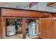 Under-sink view of a kitchen with a water filtration system and garbage disposal at 15635 W Montecito Ave, Goodyear, AZ 85395