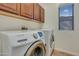 Laundry room featuring a newer model Samsung washer and dryer and upper cabinets at 15635 W Montecito Ave, Goodyear, AZ 85395