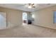 Large living room featuring carpet floors, neutral walls, and access to the ensuite bathroom at 15635 W Montecito Ave, Goodyear, AZ 85395